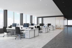 A tidy office workspace with organized desk, modern decor, and efficient lighting.